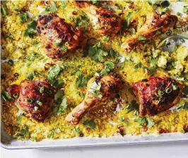  ?? LINDA XIAO / THE NEW YORK TIMES ?? Sheet pan turmeric chicken with crispy rice. Cooking rice on a sheet pan lets it crisp up gloriously, adding crunch to this classic weeknight pairing.