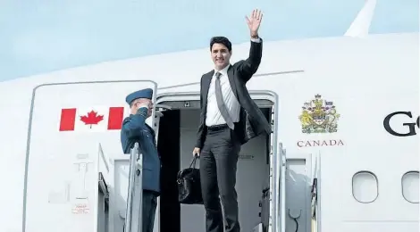  ?? SEAN KILPATRICK/THE CANADIAN PRESS ?? Prime Minister Justin Trudeau waves from the stairs of his plane as he departs Ottawa on Wednesday, on route to Europe.