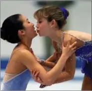  ?? ERIC DRAPER — THE ASSOCIATED PRESS ?? Michelle Kwan, left, kisses fellow American Tara Lipinski during the 1998 awards ceremony at the ladies free skating long program at the White Ring Arena in Nagano, Japan. As men’s figure skating pushes the envelope with an expanding repertoire of...