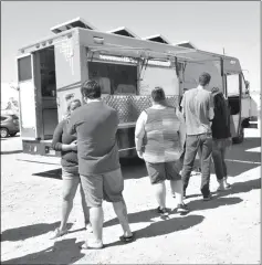  ??  ?? Yumans line up for some food at the Mobile Moo Shu truck.