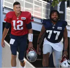  ?? NANCY LANE / BOSTON HERALD ?? TWO GOOD: Tom Brady and Michael Bennett hit the practice field.