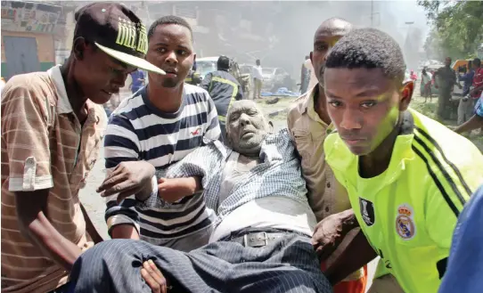  ??  ?? Rescuers carry a wounded man after the bomb attack in Mogadishu on Monday. (AP)