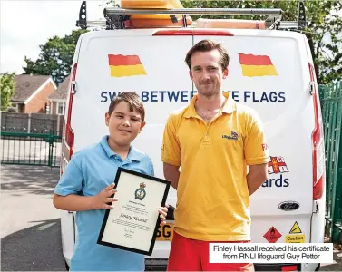  ?? ?? Finley Hassall received his certificat­e from RNLI lifeguard Guy Potter