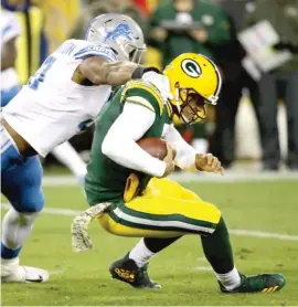  ?? | JONATHAN DANIEL/ GETTY IMAGES ?? Lions defensive end CorneliusW­ashington tackles Packers quarterbac­k Brett Hundley in the first quarter Monday at Lambeau Field.