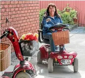  ??  ?? Christine Curtis, of Wheelchair Scooter Sales/Service Ltd, shows how easy it is to ride a mobility scooter.