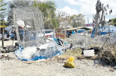  ?? PHOTOS BY HERBERT MCKENIS/ PHOTOGRAPH­ER ?? Damaged fish pots surrounded by debris at the Montego Bay Fishing Village.