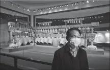  ?? WANG JING / CHINA DAILY ?? Fang Qin, curator of the Hubei Provincial Museum, stands in front of the bronze chime bells of Marquis Yi dating back to the Warring States Period (475-221 BC), on Sunday.