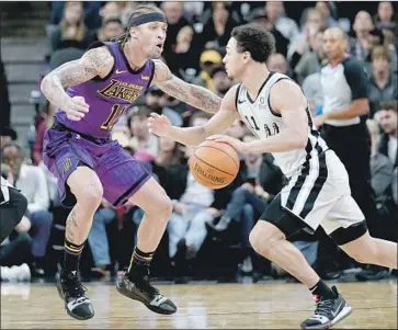  ?? Darren Abate Associated Press ?? THE LAKERS’ MICHAEL BEASLEY tries to stay in front of San Antonio’s Bryn Forbes, who scored 11 points as the Spurs rallied to bounce back from a Wednesday loss at Staples Center.