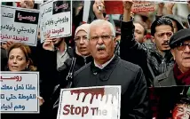  ?? PHOTO: AP ?? Former Syrian opposition leader George Sabra, centre, chants slogans as he joins others protesting attacks on the rebel-held suburb of Eastern Ghouta in Syria’s capital, Damascus, during a rally outside the Russian Consulate in Istanbul, Turkey.