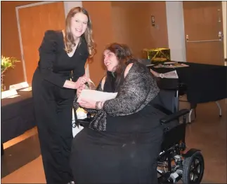  ?? CALLIE JONES — STERLING JOURNAL-ADVOCATE ?? Logan County Chamber of Commerce Board President Brianna Mcbride presents the Citizen of the Year Award to Delinda Korrey Mcdowell at the Chamber’s awards banquet Saturday, Feb. 25, 2023.