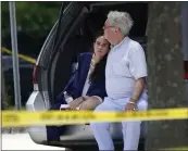  ?? GERALD HERBERT — THE ASSOCIATED PRESS ?? A man comforts a young woman wearing a graduation gown within the crime scene of a shooting at Xavier University in New Orleans on Tuesday.