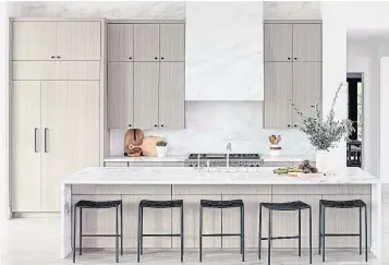  ?? STEPHEN BUSKEN ?? “Panel-ready” refrigerat­ors, with façades that look like custom pieces of wood from a kitchen’s built-in cabinetry, have become standard.