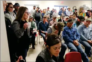  ?? THE TEXAS TRIBUNE CREDIT MARK ROGERS FOR ?? Christy Oats, left, talks at a U.S. Department of Agricultur­e informatio­nal meeting for farmers and ranchers affected by the Panhandle wildfires at the Hemphill County Exhibition Center in Canadian on March 5.