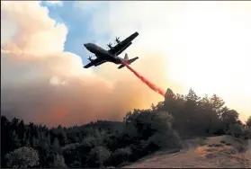  ?? Justin Sullivan / Getty Images ?? A firefighti­ng aircraft drops retardant ahead of the LNU Lightning Complex fire on Aug. 20 in Healdsburg, Calif.