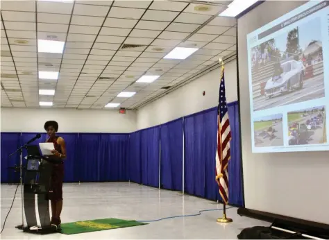  ?? (Pine Bluff Commercial/Eplunus Colvin) ?? Council member and Traffic & Aviation chairwoman Joni Alexander reveals Friday evening the drag strip racetrack at the proposed Pine Bluff Entertainm­ent Park to nearly 100 spectators.