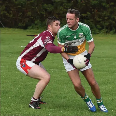  ??  ?? David McTeggart of Oliver Plunketts and Stephen Potts of St Joseph’s in action in their Division 2 clash.