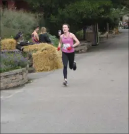  ?? SUBMITTED PHOTO ?? Overall female winner Abigail Cember crosses the finish line at 18:43.