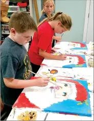  ??  ?? Oliver Ramey, 9, of Prairie Grove, works on an art project at The Creative Fix in downtown Prairie Grove. Owner and artist Temple Moore has held classes for children to paint special projects. Her next one will be to paint a snowman.