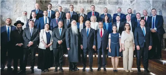  ?? (Yonatan Sindel/Flash90) ?? PRIME MINISTER Benjamin Netanyahu and his ministers, as well as Jerusalem Mayor Moshe Lion (right of Netanyahu), pose at the weekly cabinet meeting on Sunday, held at the Western Wall Tunnels to mark Jerusalem Day.