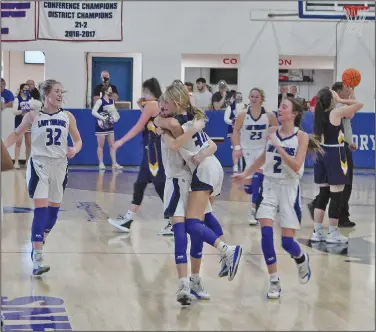  ?? Wes Taylor/Special to the News-Times ?? Headed to state: Members of Parkers Chapel’s girls basketball team celebrate after clinching a spot in the 2A State Tournament with a 48-38 win over Poyen in the opening round of the 2A South Regional Tournament at Caddo Hills on Thursday. The Lady Trojans took on Murfreesbo­ro in the semifinals on Friday.