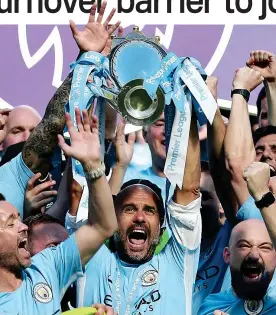  ?? PA ?? On the up: Guardiola (centre) celebrates City’s title success