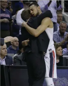  ?? BEN MARGOT — THE ASSOCIATED PRESS ?? Gonzaga guard Nigel Williams-Goss is hugged by coach Mark Few in the closing minutes of the Zags’ win over Xavier.
