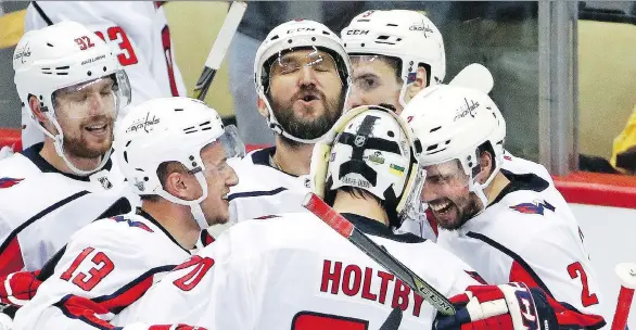  ?? GENE J. PUSKAR/THE ASSOCIATED PRESS ?? Alex Ovechkin and his Washington Capitals celebrate Monday night after they finally beat the Pittsburgh Penguins in a playoff series.