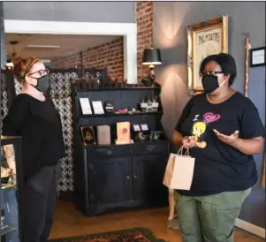  ?? The Sentinel-Record/Grace Brown ?? SHOPPING LOCAL: Breyona Canady, right, speaks to shop owner Amy Davis after making a purchase at The Parlor Hot Springs, 340 Ouachita Ave., on Wednesday. The Parlor will be selling face masks starting on Saturday.
