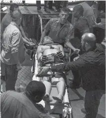  ??  ?? Fred Stonehouse, on a stretcher and in a neck brace, is removed from the cage after losing consciousn­ess.