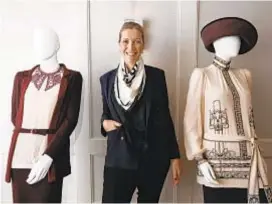  ?? Genaro Molina Los Angeles Times ?? COSTUME designer Anna Robbins, a two-time Emmy nominee, with two of her creations for the “Downton Abbey” movie.