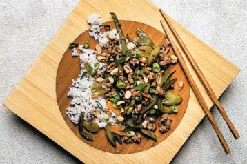  ?? GORAN KOSANOVIC/PHOTOS FOR THE WASHINGTON POST ?? Celery takes center stage in this stir-fry dish that also includes a small portion of pork served over steamed white rice.