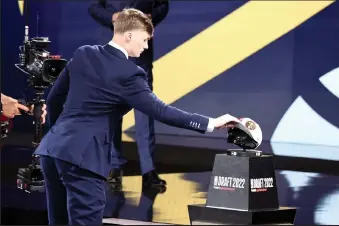  ?? Arturo Holmes / Getty Images North America ?? Christian Braun grabs a hat after being drafted 21st overall by the Denver Nuggets during the 2022 NBA Draft at Barclays Center on June 23, 2022 in New York City.