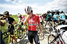  ?? — AFP photo ?? Riders clean their stinging eyes after tear gas was used during a farmers’ protest who attempted to block the stage’s route, during the 16th stage of the 105th edition of the Tour de France cycling race, between Carcassonn­e and Bagneres-de-Luchon, southweste­rn France.