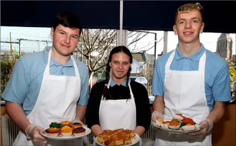  ??  ?? Our Lady of Fatima School students Mick Sheehan, Gemma O’Brien and Brian Power helping out at the cake sale in aid of Age Action Ireland on Friday morning in the school.