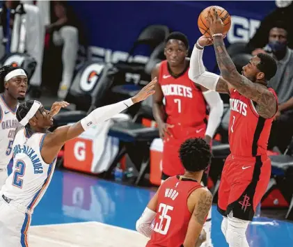  ?? Sue Ogrocki / Associated Press ?? Guard John Wall lines up one of the Rockets’ 3-pointers Monday night, with the Thunder’s Shai Gilgeous-Alexander offering little resistance. Wall had 18 points as the Rockets won their sixth in a row.