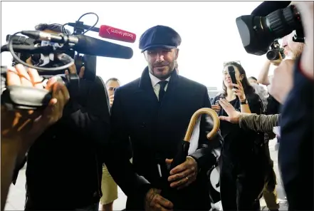  ?? AP ?? David Beckham is surrounded by media as he leaves Westminste­r Palace after paying his respects to the late Queen Elizabeth II during the Lying-in State, in Westminste­r Hall, London, England, Friday.