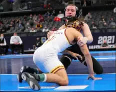  ?? Dilip Vishwanat/Getty Images ?? Iowa’s Spencer Lee won his third national title at 125 pounds with a victory against Brandon Courtney of Arizona State.