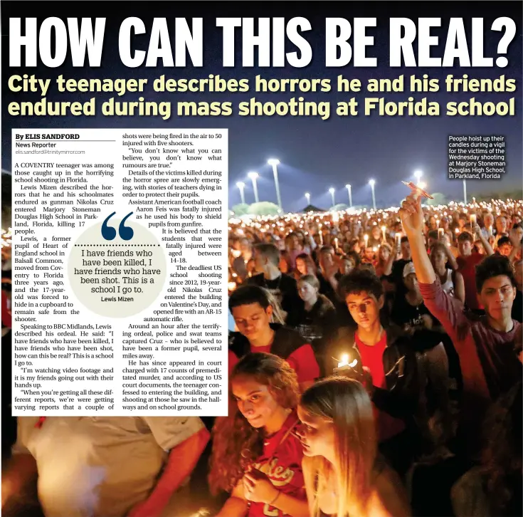  ??  ?? People hoist up their candles during a vigil for the victims of the Wednesday shooting at Marjory Stoneman Douglas High School, in Parkland, Florida
