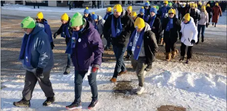  ?? ?? Teams walk along the route through downtown Swift Current during the 2022 CNOY community walk.