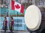  ??  ?? The Canadian flag is raised during a festive ceremony. “It was amazing,” said women’s hockey player Natalie Spooner. “The fact we got involved in the dancing was something we were super excited about.”