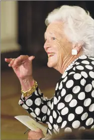  ?? Mike Theiler / AFP / Getty Images ?? Former first lady Barbara Bush waves to a participan­t at the White House Conference on School Libraries attended by first lady Laura Bush in the East Room of the White House in Washington in June of 2002.