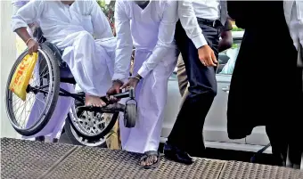  ??  ?? This scene last week at the Supreme Court complex shows a wheelchair -bound man having to be lifted due to the lack of accessibil­ity