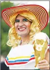  ??  ?? A fan poses for a photograph­er prior to the opening match between Russia and Saudi Arabia during the 2018 soccer World Cup at the Luzhniki Stadium in Moscow, Russia
on June 14. (AP)