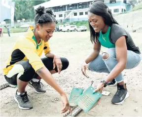  ?? CONTRIBUTE­D ?? Olympian Christania Williams, a past student of Edwin Allen High School, discusses proper placement of track equipment during FLOW’s ‘Journey to Champs’ visit to the institutio­n.
