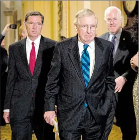  ?? AP/J. SCOTT APPLEWHITE ?? Senate Majority Leader Mitch McConnell (center) leaves a closed strategy session Tuesday on Capitol Hill with Sen. John Barrasso (left) of Wyoming and Senate Majority Whip John Cornyn of Texas.