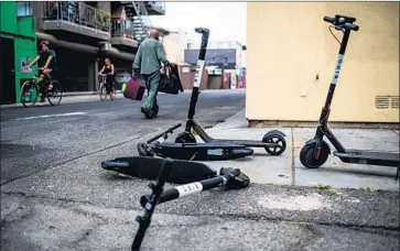  ?? Gabriel S. Scarlett Los Angeles Times ?? ELECTRIC SCOOTERS in an alley near the Venice boardwalk. Councilman Paul Koretz has called for banning the vehicles while L.A. develops rules for scooter companies. A decision is “a few months away,” he said