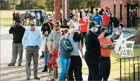  ?? SEAN RAYFORD/GETTY ?? A long line of voters wait to cast their ballots Tuesday at Savannah Grove Baptist Church in Effingham, South Carolina.