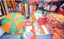  ?? (ANI) ?? A vendor sells flags and umbrellas printed with symbols of different policital parties, in Kolkata, India on Monday