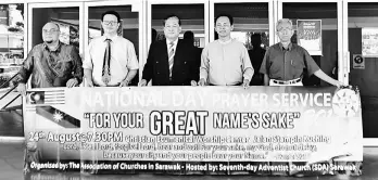  ??  ?? (From left) Terry, Brian, Ambrose, Jacob and Attie hold the prayer service banner.