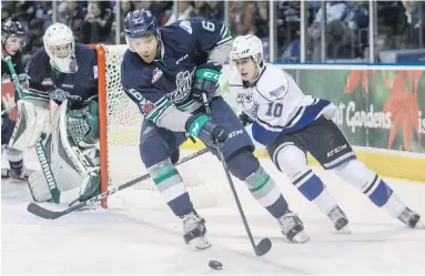  ??  ?? Victoria Royals’ Ryan Peckford (10) checks Seattle Thunderbir­ds’ Aaron Hyman in WHL action at the Save-on-Foods Memorial Centre on Saturday. The Royals won 2-1.